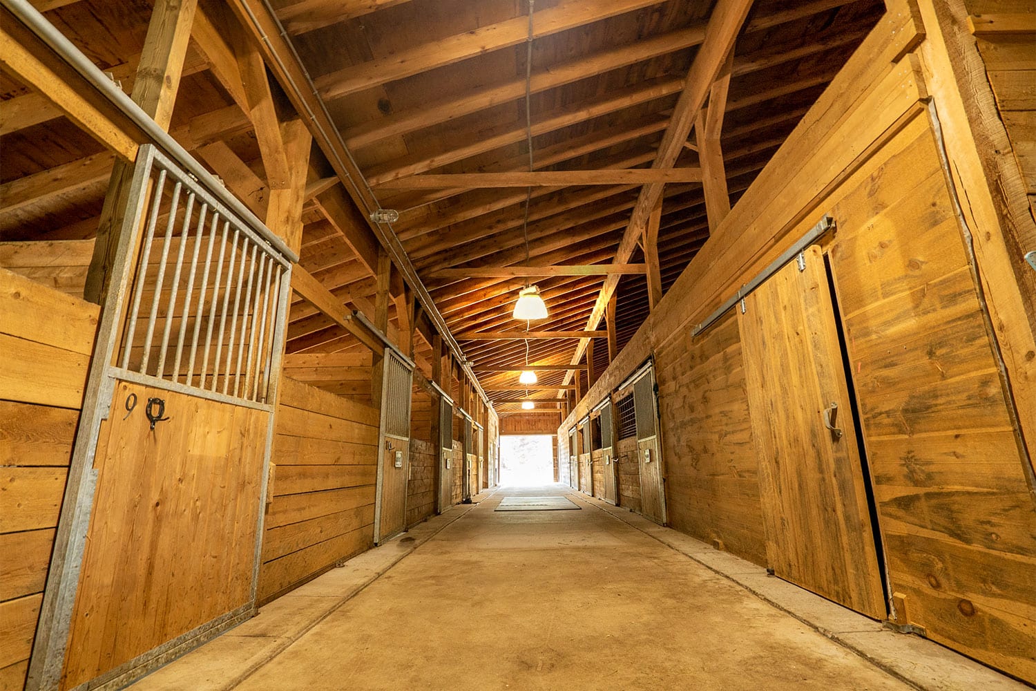 A photo of the horse stalls and arena at Foundation House's FoxHole Ranch.