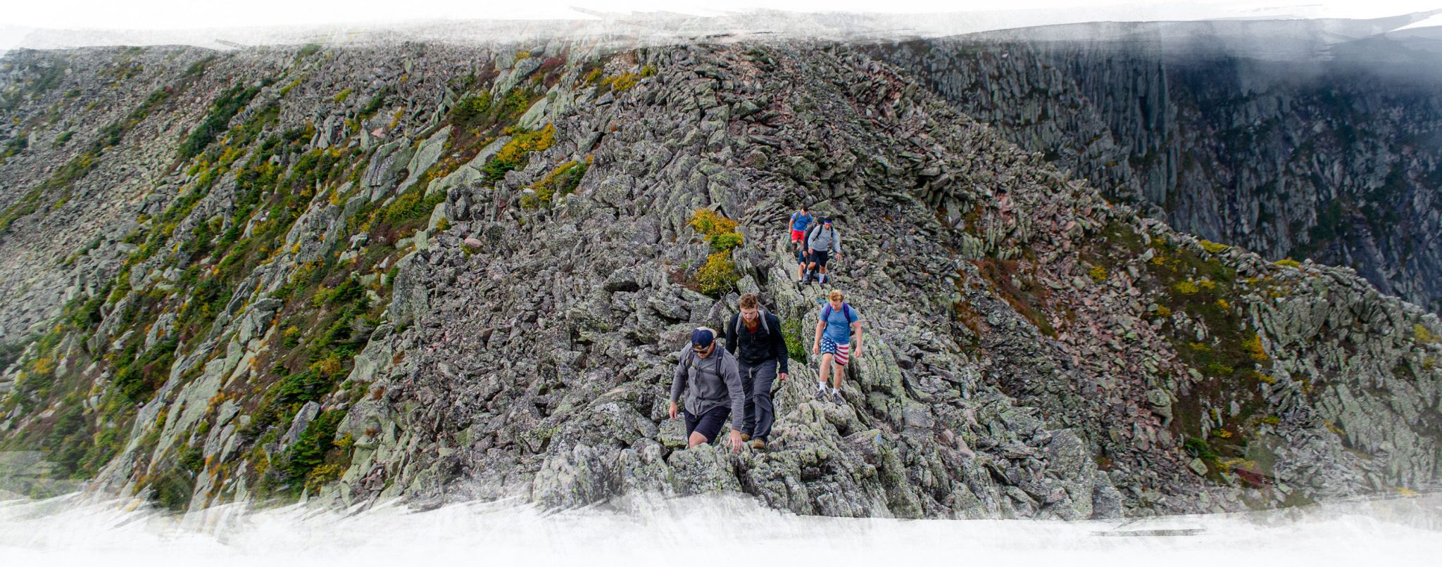 A photo of Foundation House men in recovery climbing the Mount Katahdin Knife's Edge.