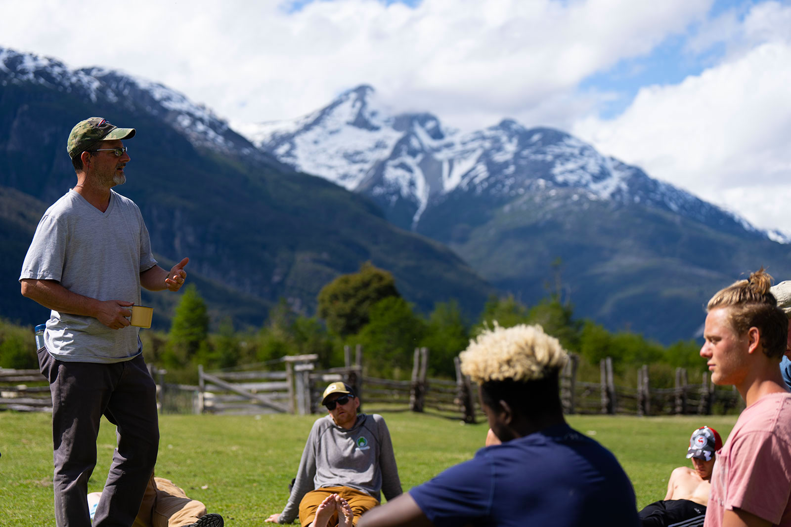 Patrick leads a group discussion about recovery outside in a picturesque Patagonia, Chile valley